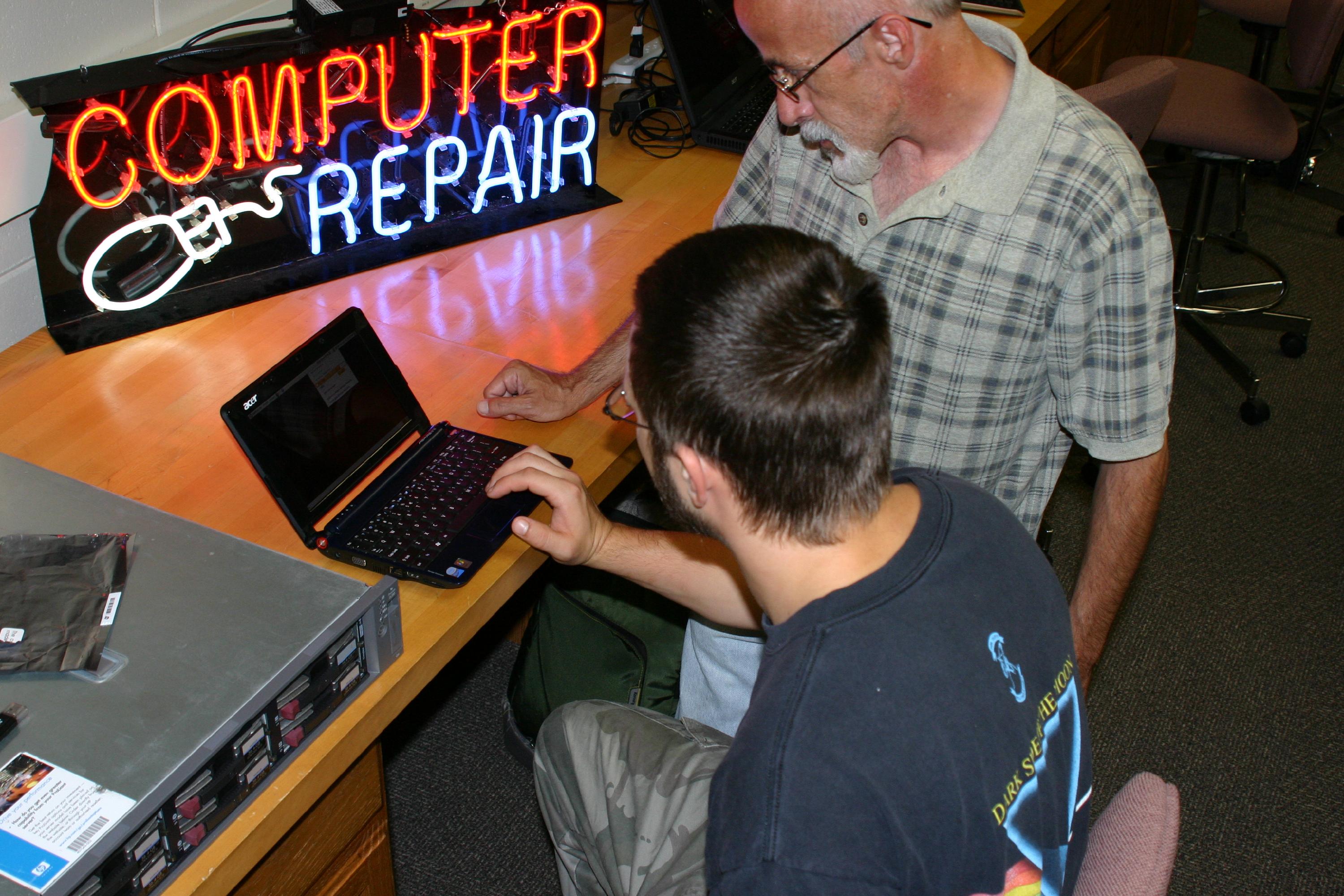 Student and instructor working on computer
